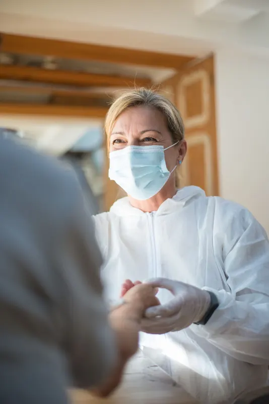 A woman wearing a face mask and gloves