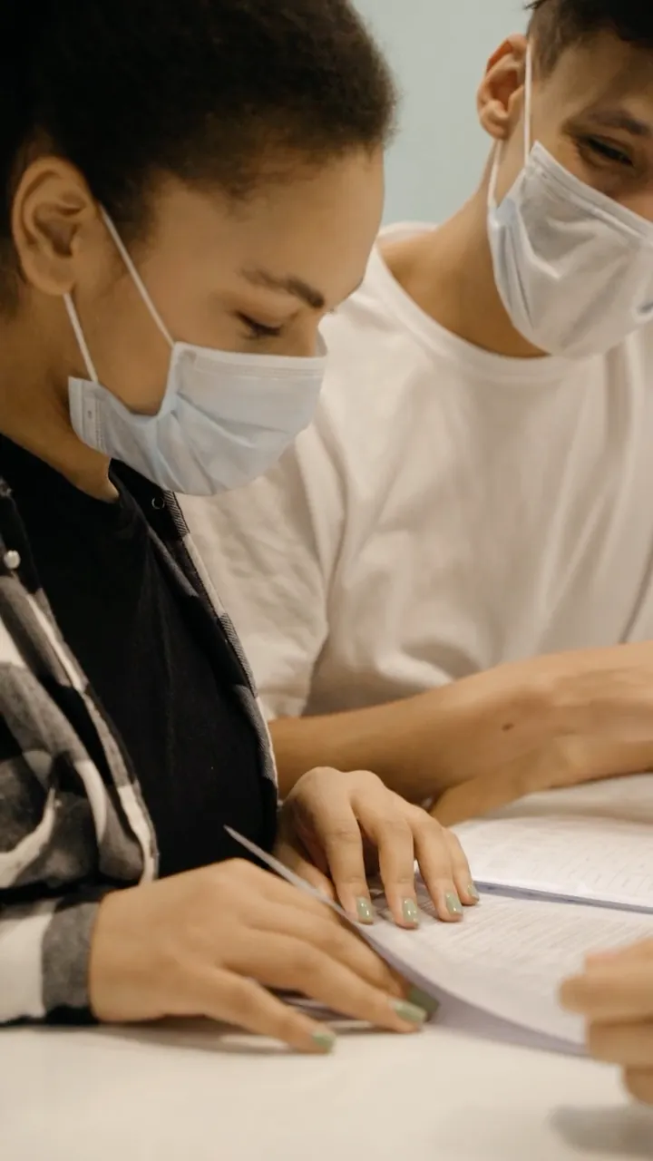 Two colleagues reading through papers together
