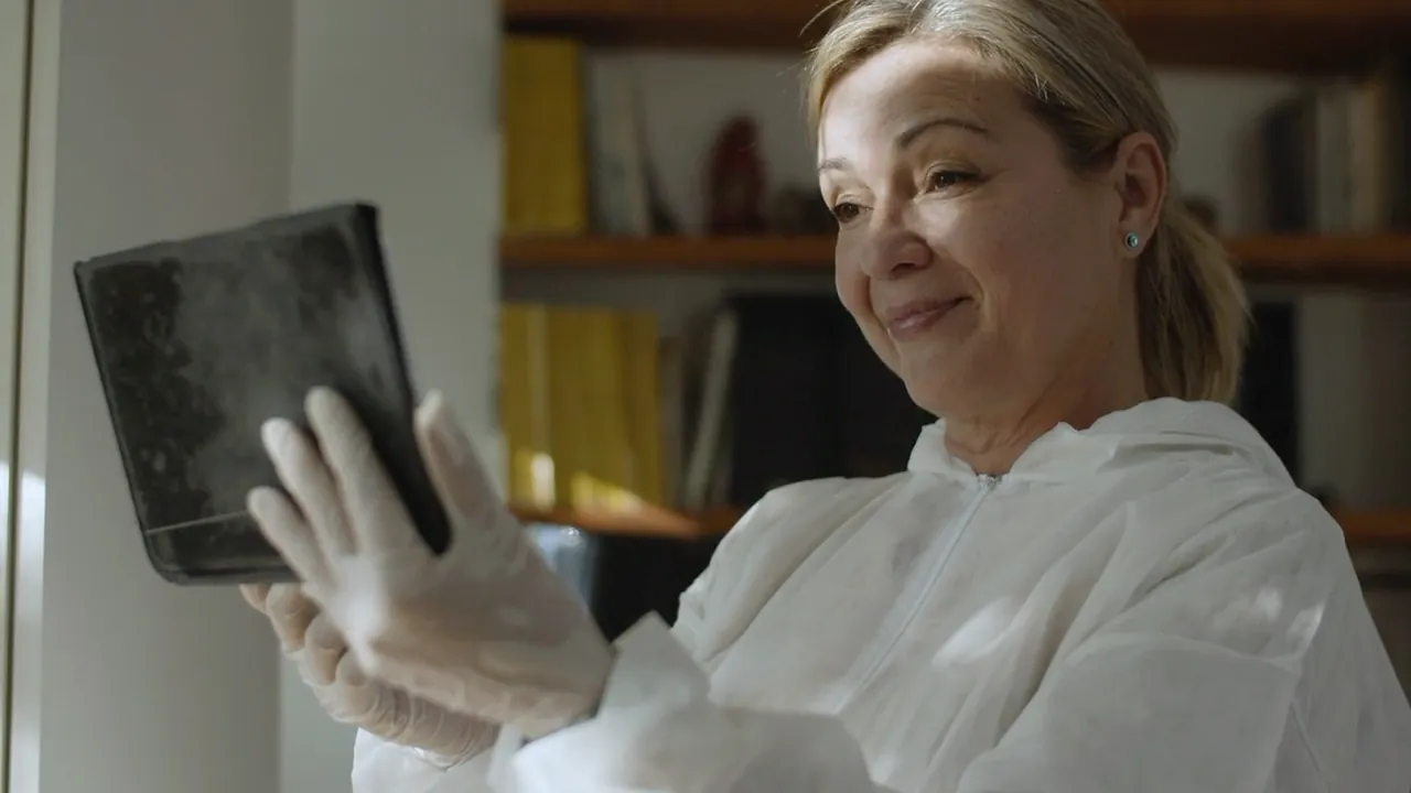A care worker smiling at a tablet